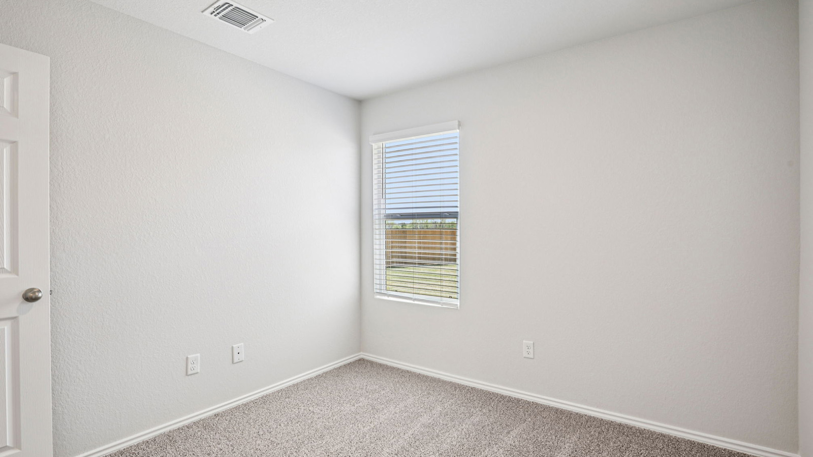 148 Wyatt Way Jarrell, TX 76537 - Photo 27 of 33 Neutral tone walls with textured finish, light grey carpet flooring, and white trim