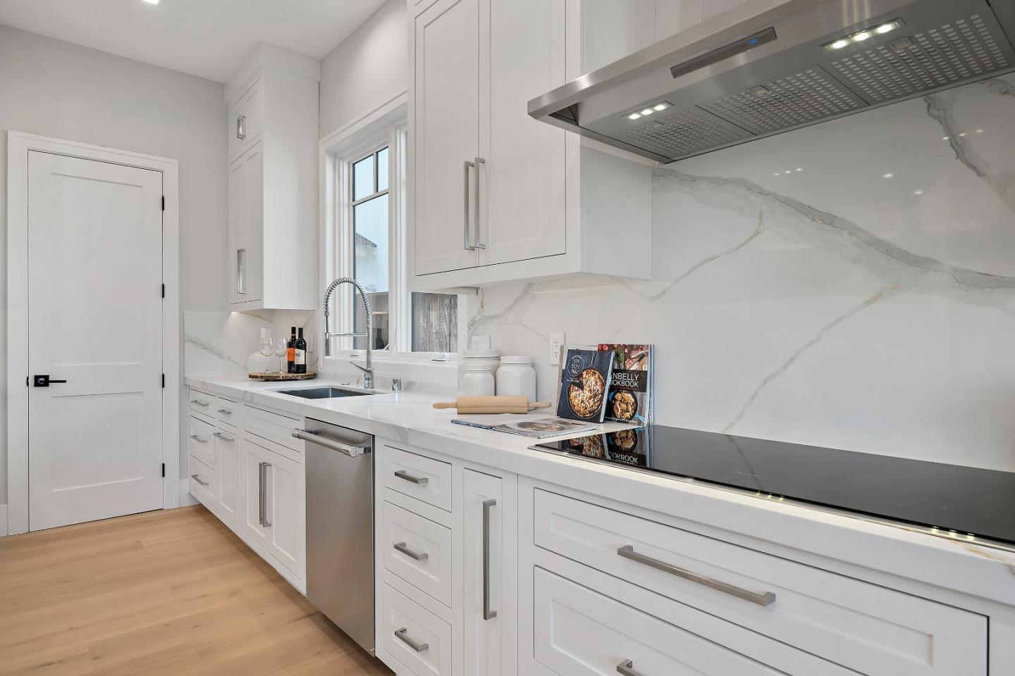 263 Belmont Avenue Redwood City, CA 94061 - Photo 12 of 32 a kitchen with white cabinets and sink