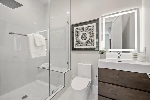 a bathroom with a toilet sink and shower