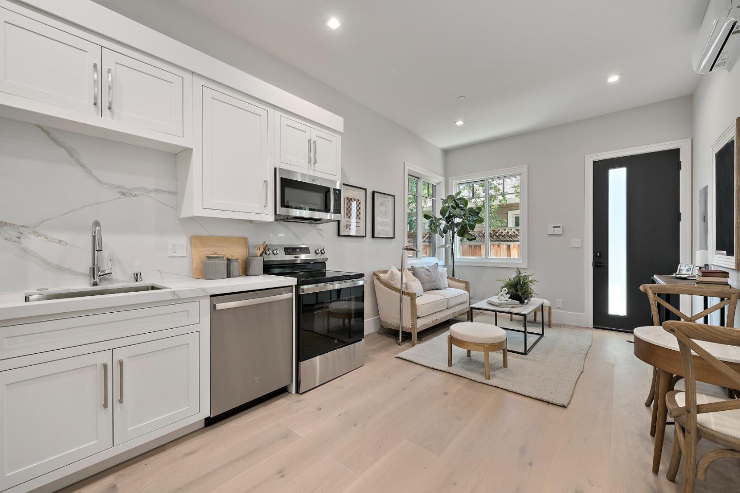 263 Belmont Avenue Redwood City, CA 94061 - Photo 17 of 32 a living room with furniture a rug kitchen view and a window