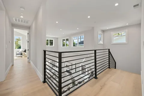 a view of a hallway with a white walls and stairs