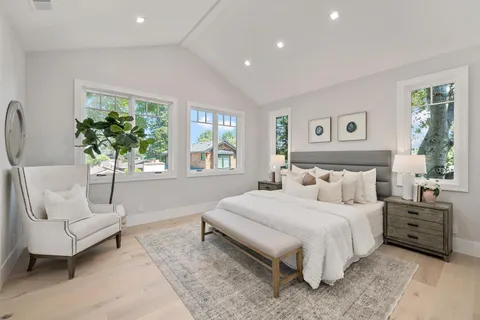 a bedroom with a large bed and a couch