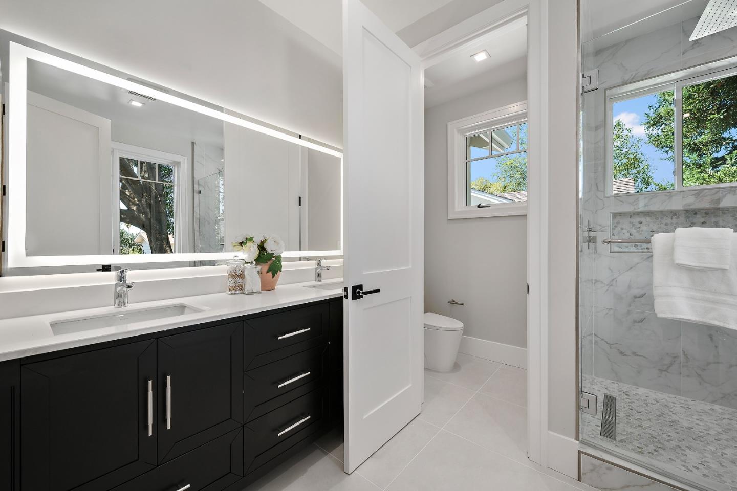 263 Belmont Avenue Redwood City, CA 94061 - Photo 22 of 32 a bathroom with a double vanity sink a toilet and a mirror