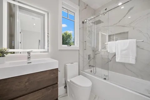 a bathroom with a sink toilet and shower