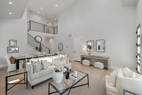 a living room with furniture and kitchen view
