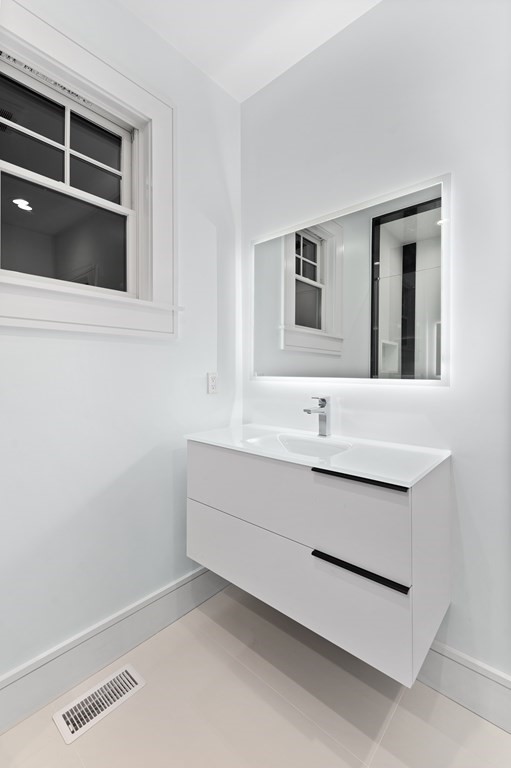 480 Dudley Road Newton, MA 02459 - Photo 30 of 35 a bathroom with a sink and a mirror