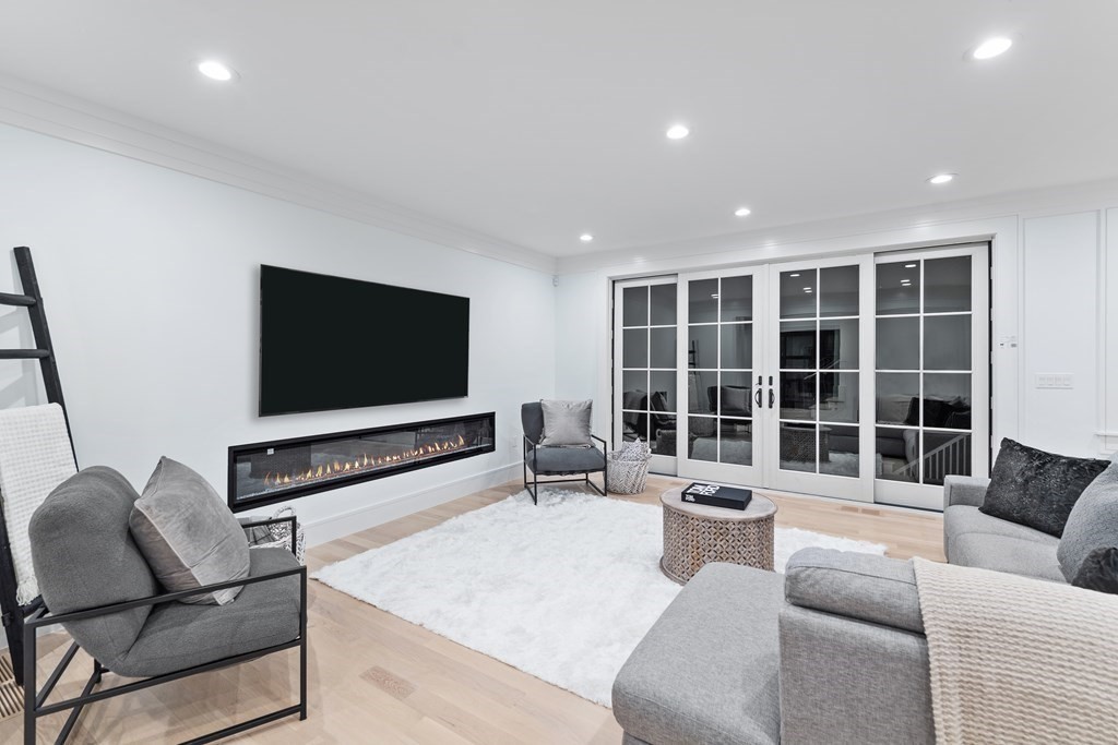 480 Dudley Road Newton, MA 02459 - Photo 6 of 35 a living room with furniture tv and a large window