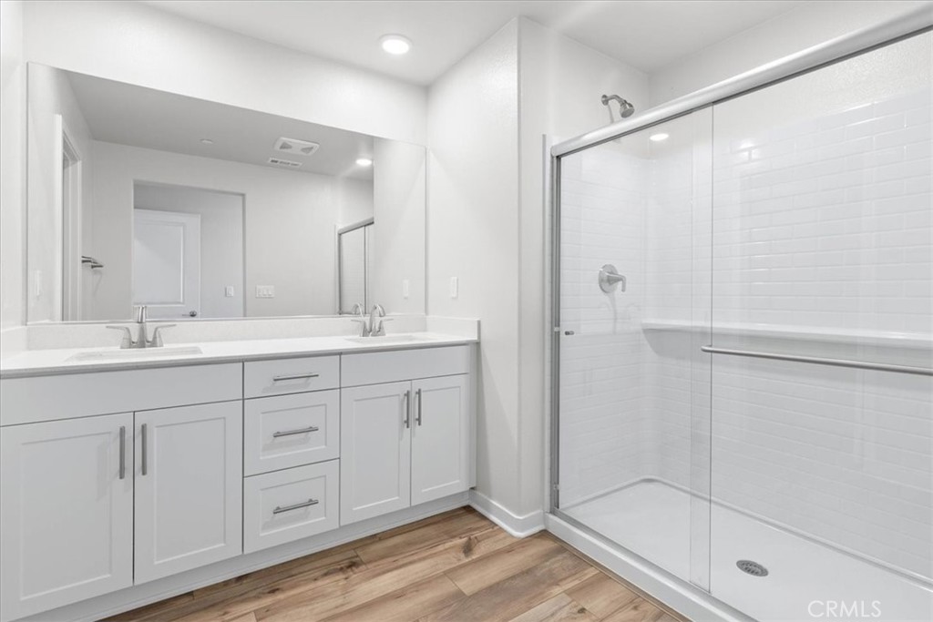 9518 Hannah Way Riverside, CA 92503 - Photo 12 of 17 a bathroom with a shower sink and mirror