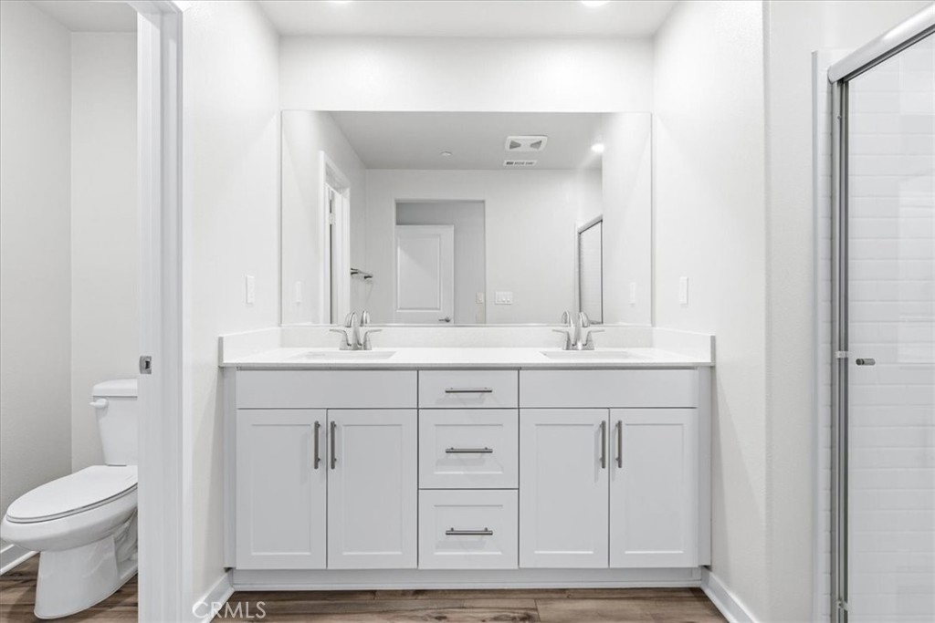 9518 Hannah Way Riverside, CA 92503 - Photo 13 of 17 a bathroom with a sink a toilet and a mirror