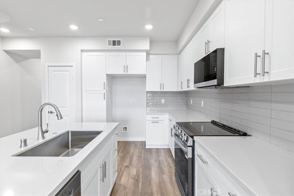 9518 Hannah Way Riverside, CA 92503 - Photo 6 of 17 a kitchen with a sink a stove and refrigerator