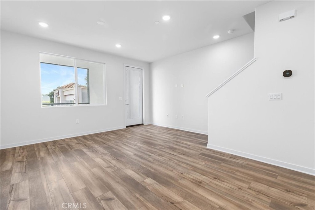 9518 Hannah Way Riverside, CA 92503 - Photo 9 of 17 an empty room with wooden floor and windows