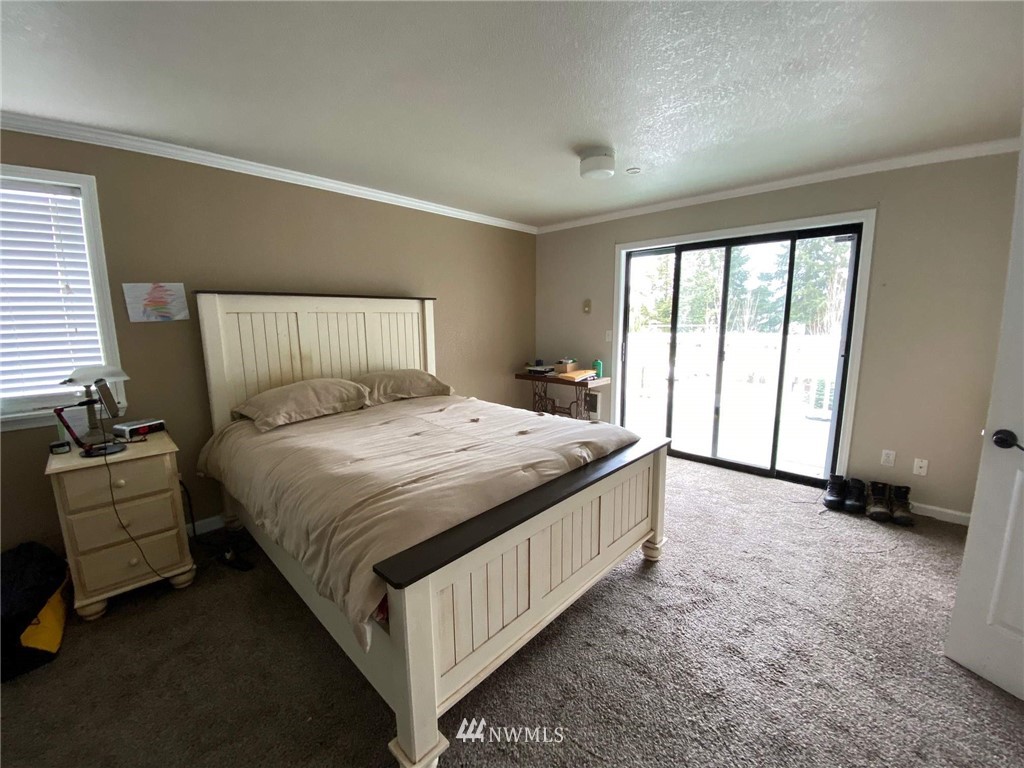 18216 Applegate Street Southwest Rochester, WA 98579 - Photo 22 of 37 a bed sitting in a bedroom next to a window