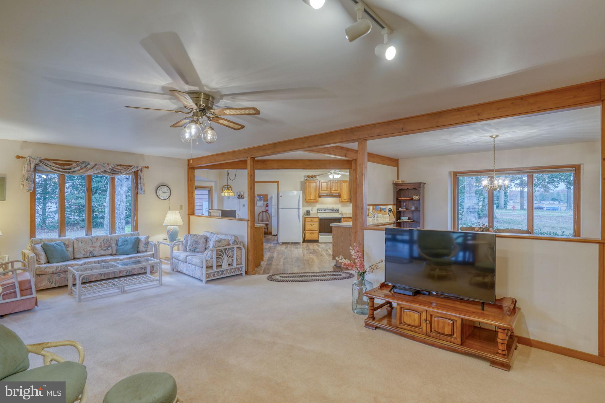 5 Bay Point Road Millsboro, DE 19966 - Photo 24 of 83 a living room with furniture gym equipment and large windows