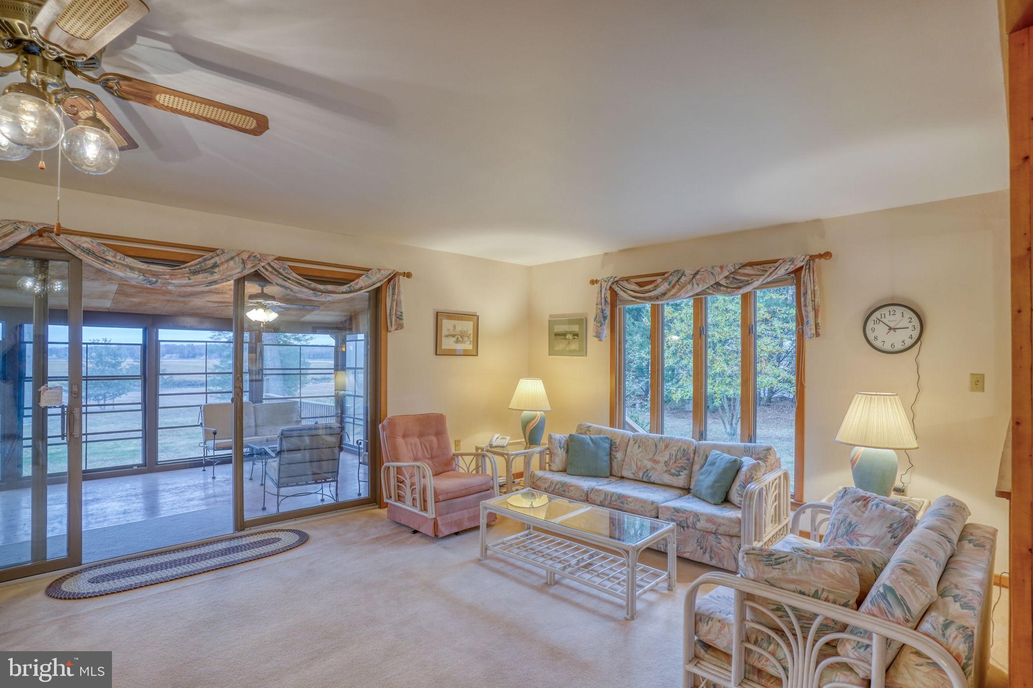 5 Bay Point Road Millsboro, DE 19966 - Photo 28 of 83 a living room with furniture and a floor to ceiling window