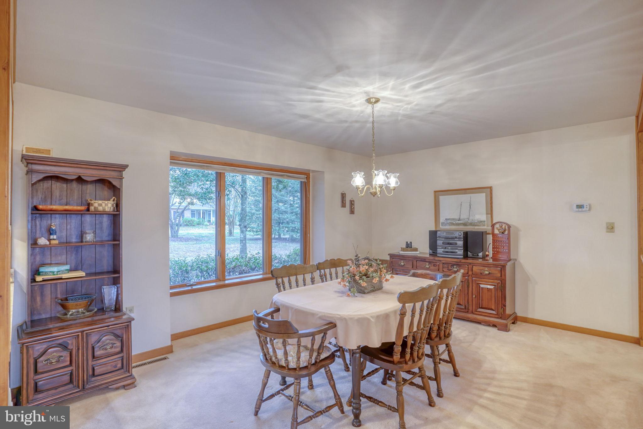 5 Bay Point Road Millsboro, DE 19966 - Photo 30 of 83 a view of a dining room with furniture chandelier and wooden floor