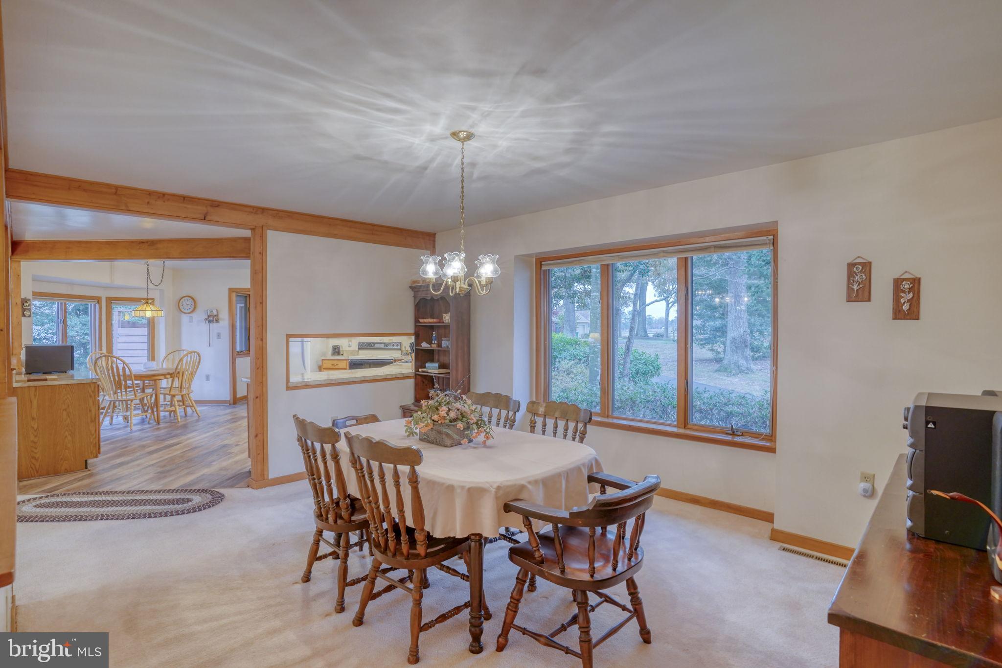 5 Bay Point Road Millsboro, DE 19966 - Photo 31 of 83 a view of a dining room with furniture wooden floor and chandelier