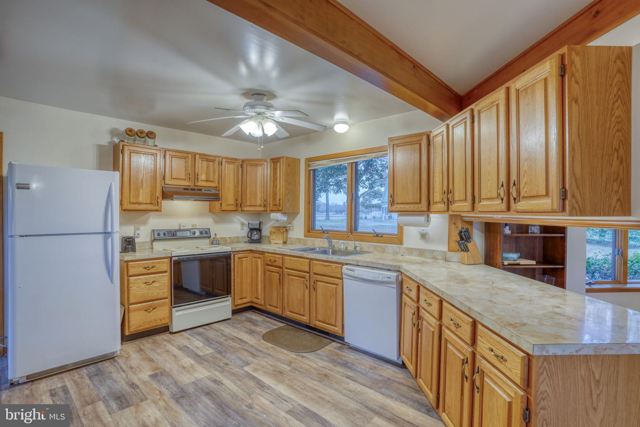5 Bay Point Road Millsboro, DE 19966 - Photo 33 of 83 a kitchen with granite countertop stainless steel appliances a sink stove and refrigerator