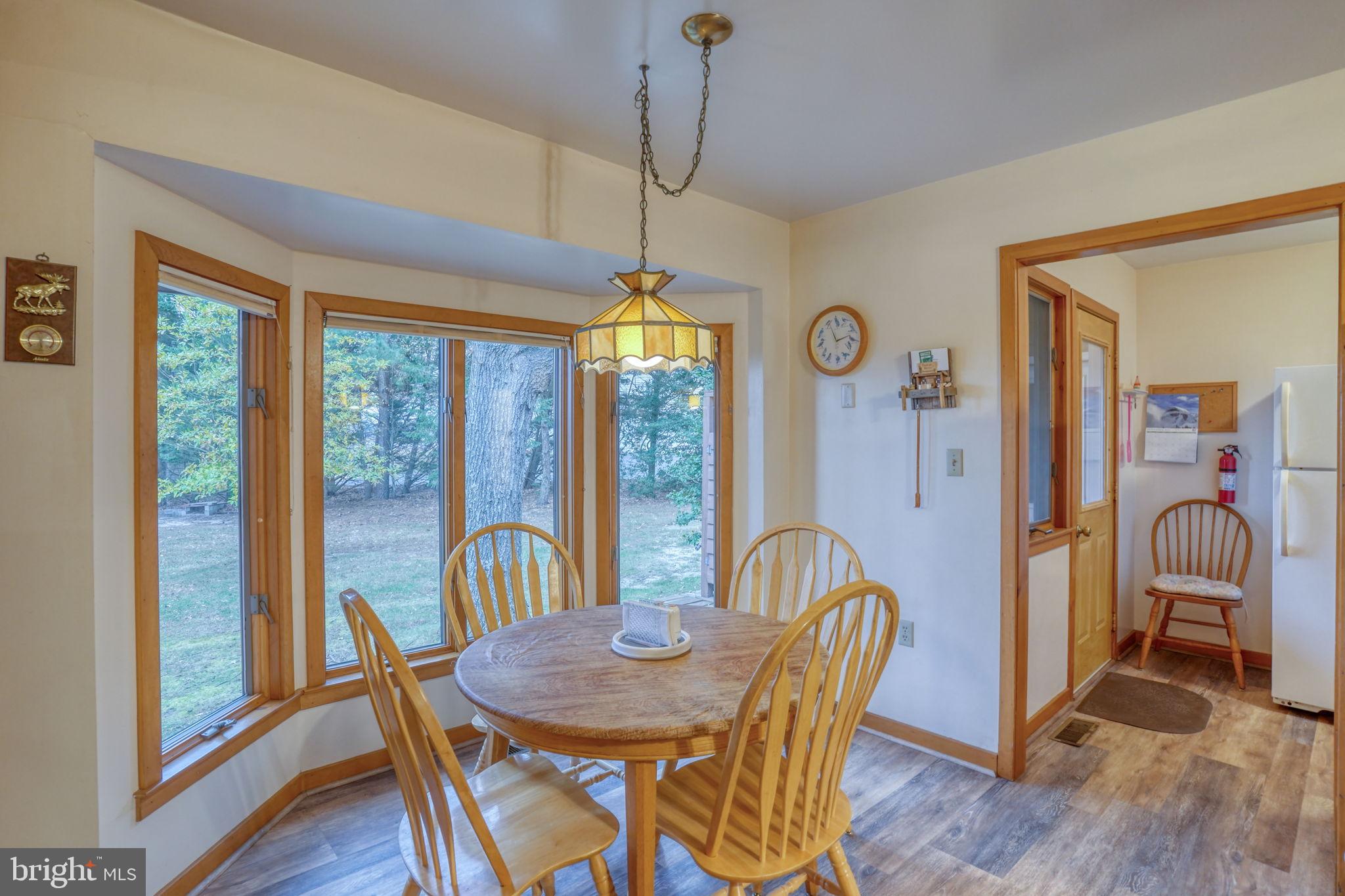 5 Bay Point Road Millsboro, DE 19966 - Photo 37 of 83 a view of a dining room with furniture window and wooden floor
