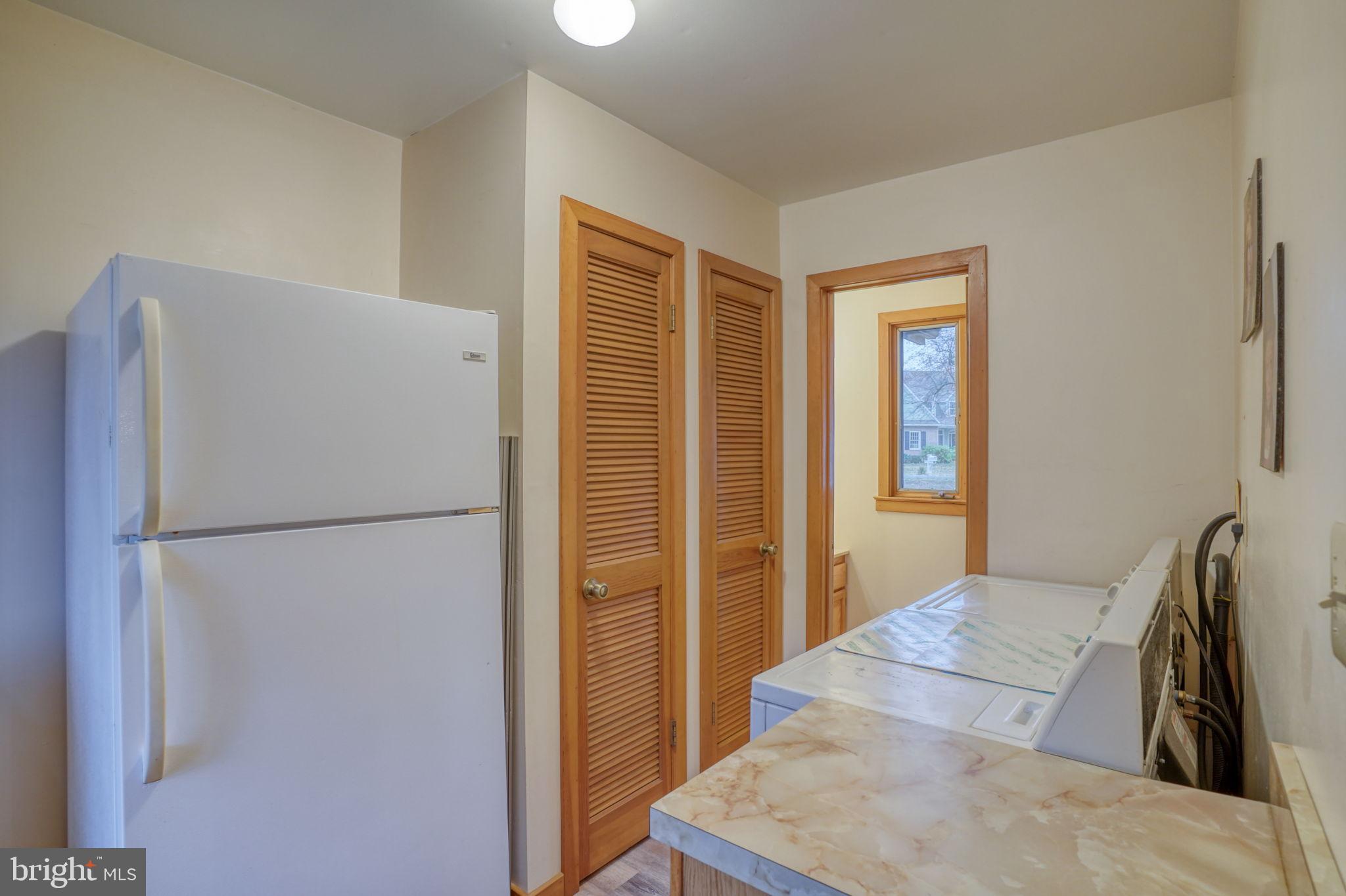 5 Bay Point Road Millsboro, DE 19966 - Photo 38 of 83 a white refrigerator freezer and a stove sitting inside of a room