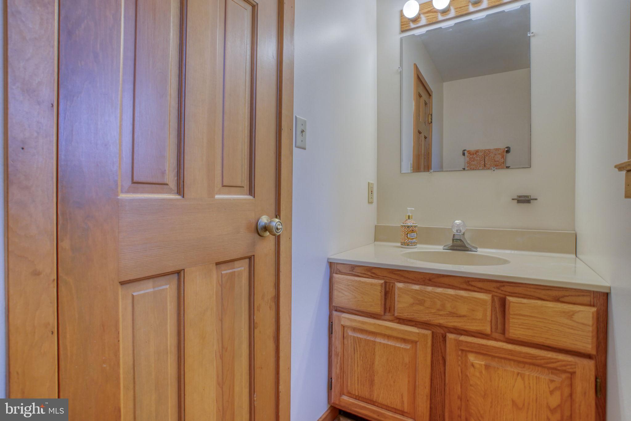 5 Bay Point Road Millsboro, DE 19966 - Photo 39 of 83 a bathroom with a granite countertop sink and a mirror