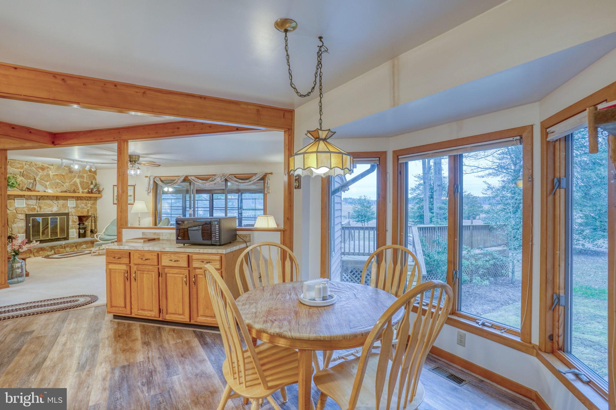 5 Bay Point Road Millsboro, DE 19966 - Photo 41 of 83 a view of a dining room with furniture large windows and wooden floor
