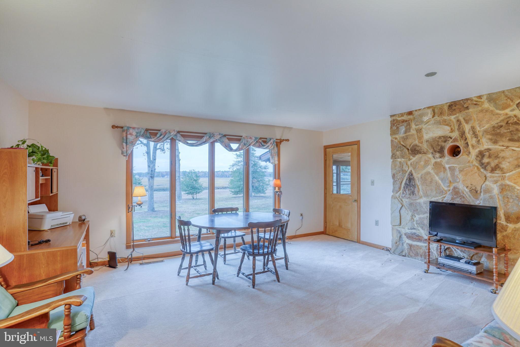 5 Bay Point Road Millsboro, DE 19966 - Photo 45 of 83 a living room with furniture and a fireplace