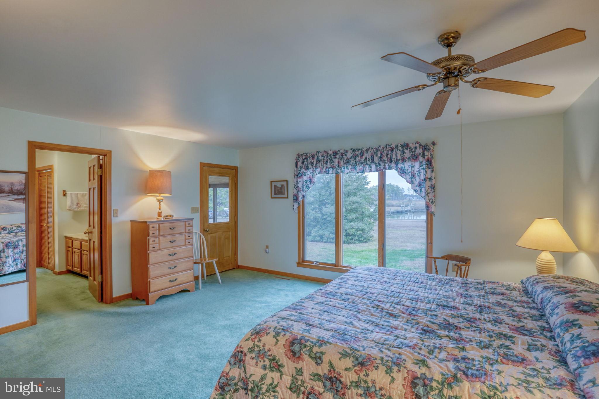 5 Bay Point Road Millsboro, DE 19966 - Photo 50 of 83 a bedroom with a bed and a chandelier