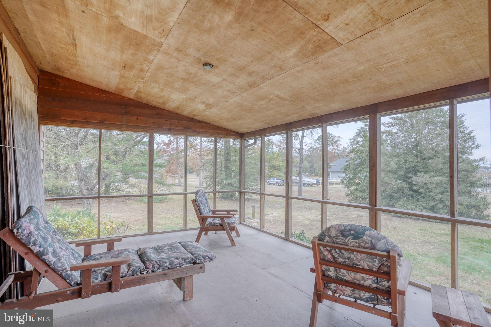 5 Bay Point Road Millsboro, DE 19966 - Photo 53 of 83 a living room with furniture and a floor to ceiling window