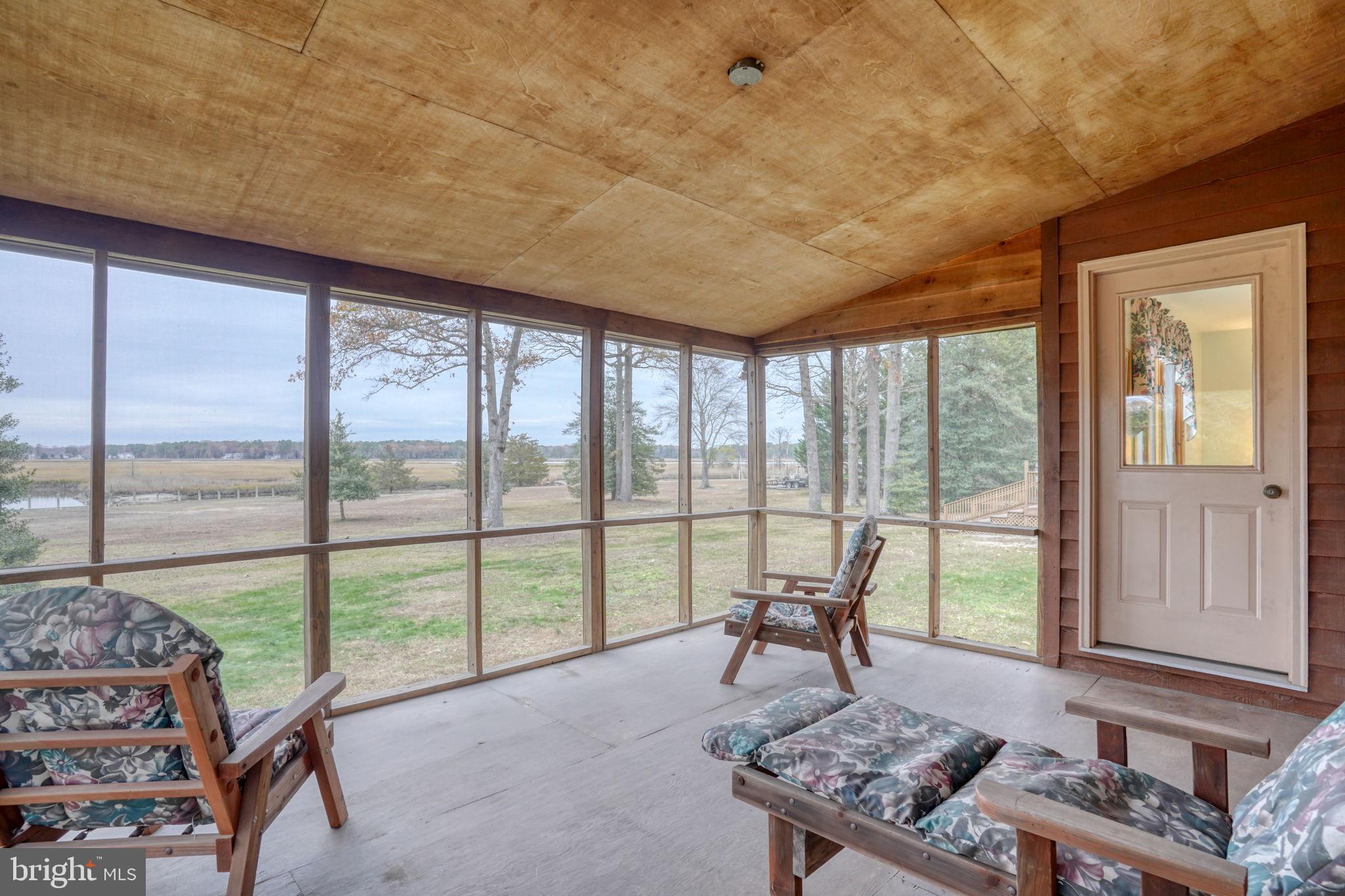 5 Bay Point Road Millsboro, DE 19966 - Photo 54 of 83 a living room with furniture and a floor to ceiling window