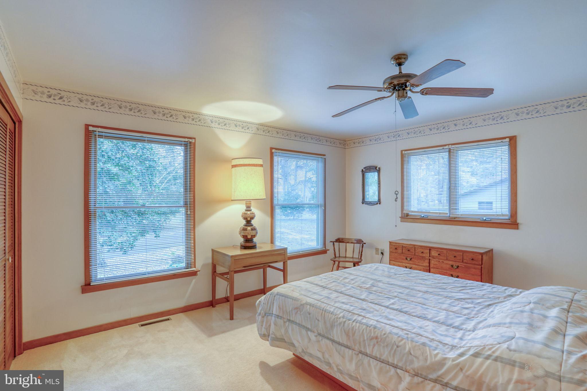 5 Bay Point Road Millsboro, DE 19966 - Photo 56 of 83 a bedroom with a bed and a chandelier