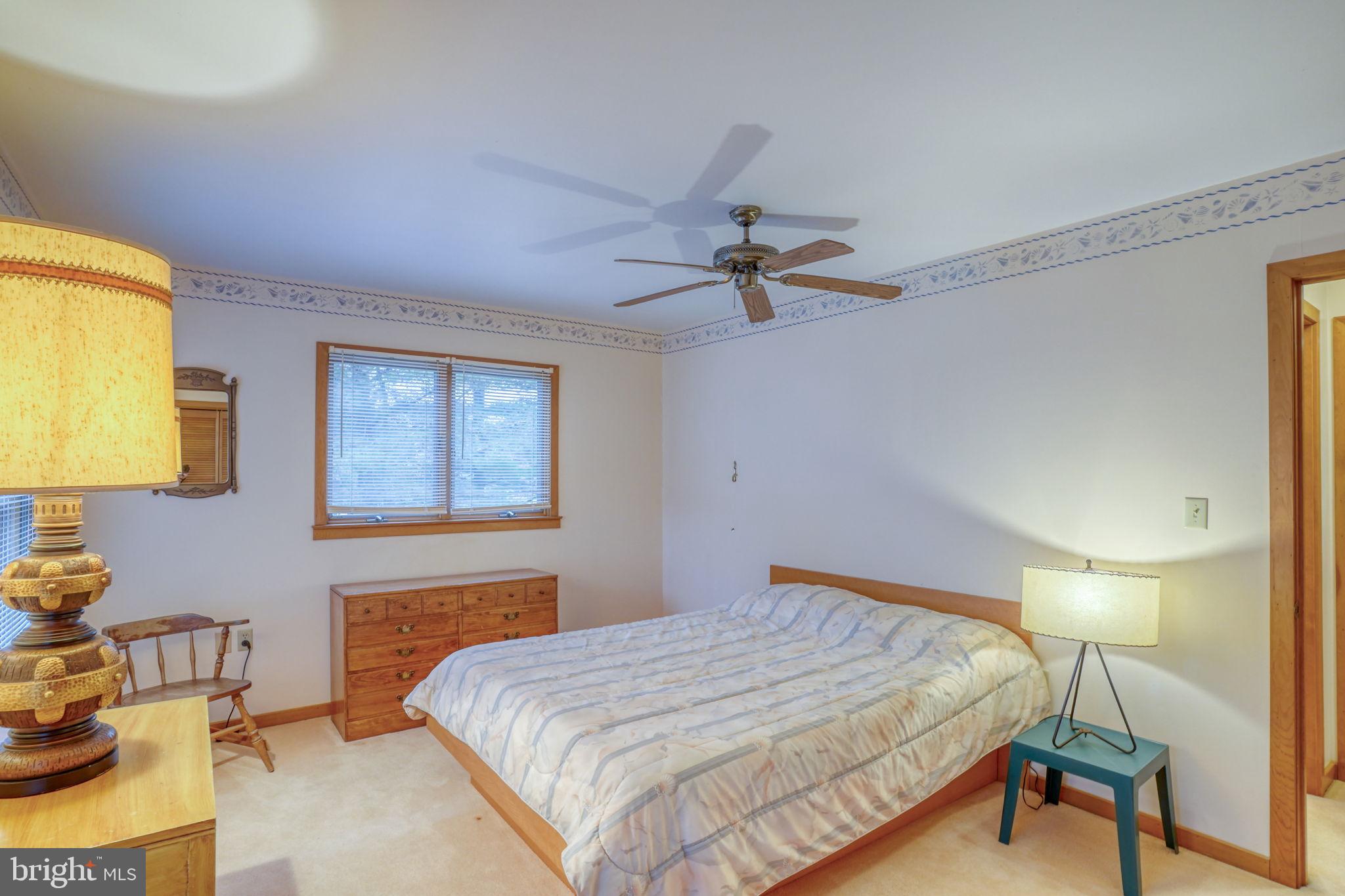 5 Bay Point Road Millsboro, DE 19966 - Photo 57 of 83 a bedroom with a bed and a table in it