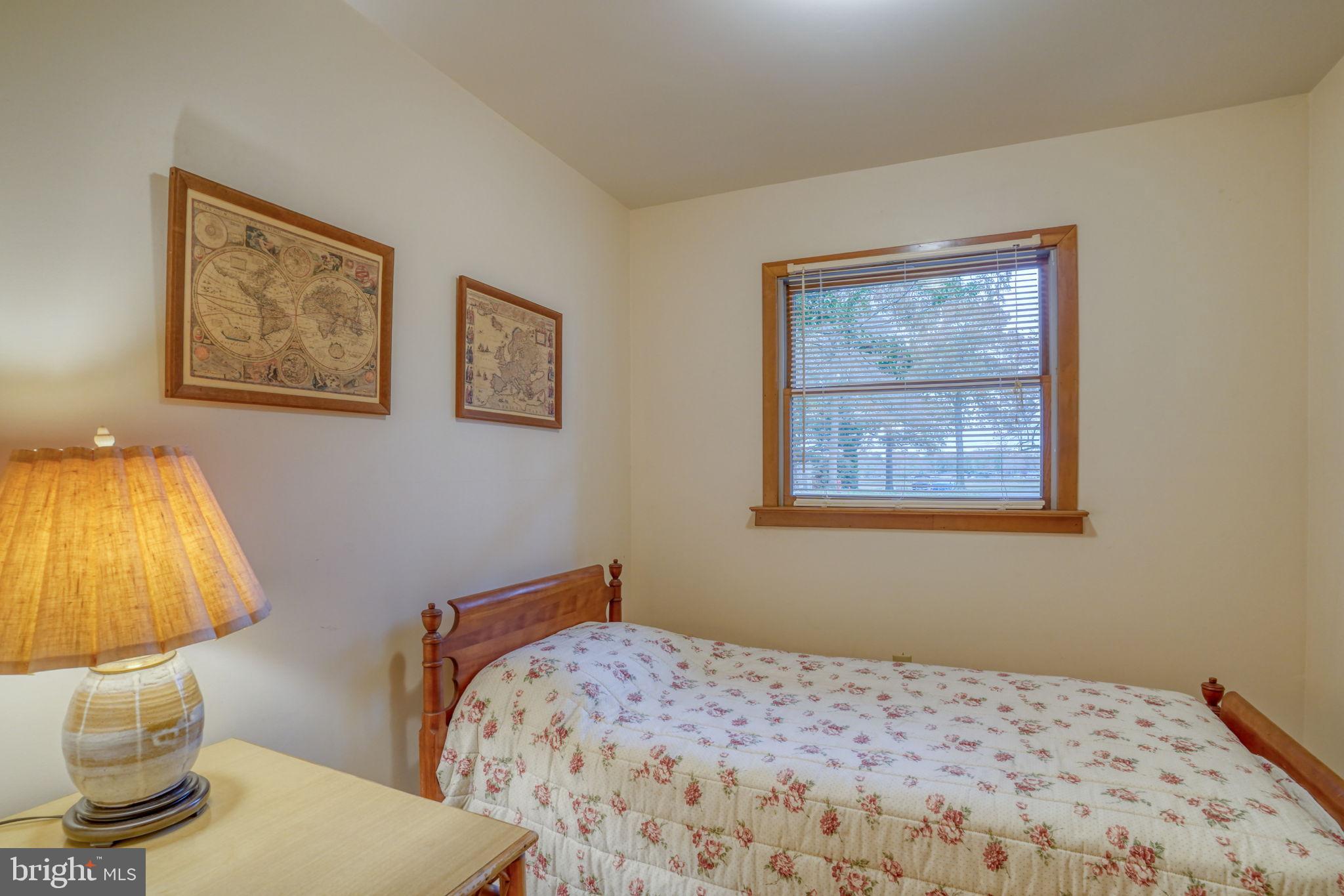 5 Bay Point Road Millsboro, DE 19966 - Photo 60 of 83 a bedroom with a bed and painting on the wall