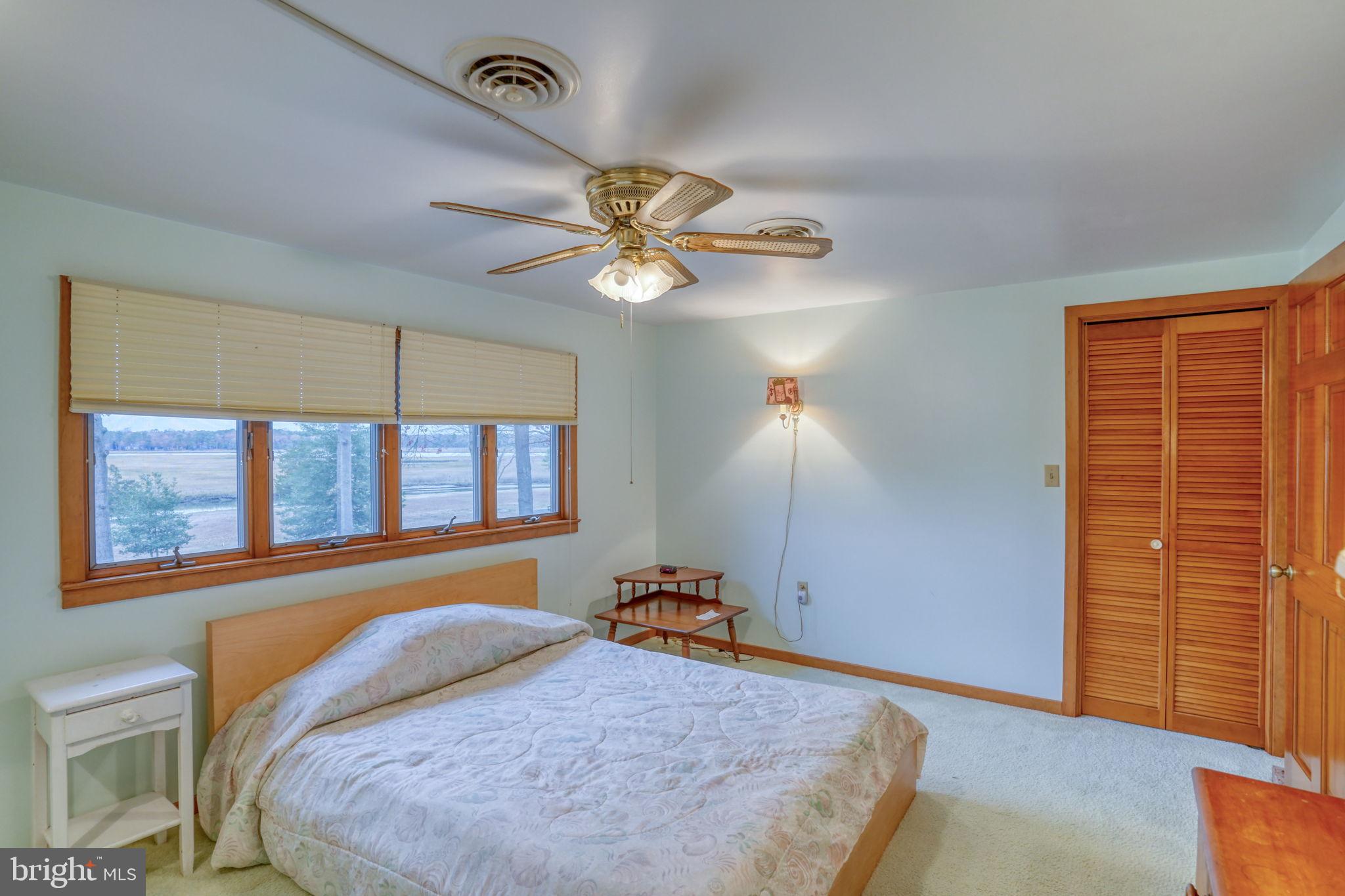 5 Bay Point Road Millsboro, DE 19966 - Photo 64 of 83 a bedroom with a bed and a chandelier
