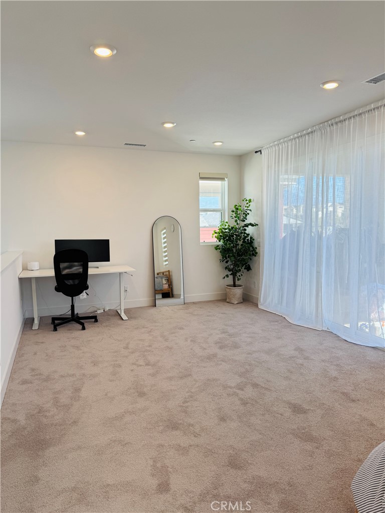 124 Yugen Irvine, CA 92618 - Photo 24 of 31 a view of a livingroom with a chair and potted plant