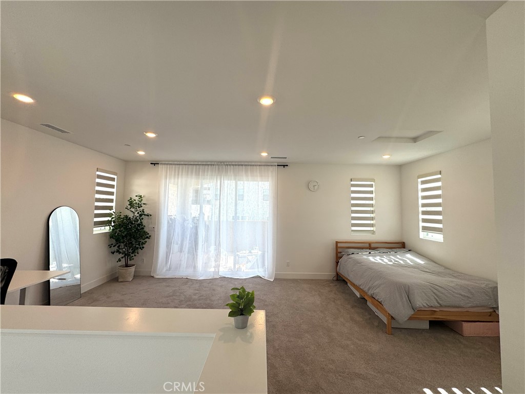 124 Yugen Irvine, CA 92618 - Photo 26 of 31 a bedroom with a bed and a window