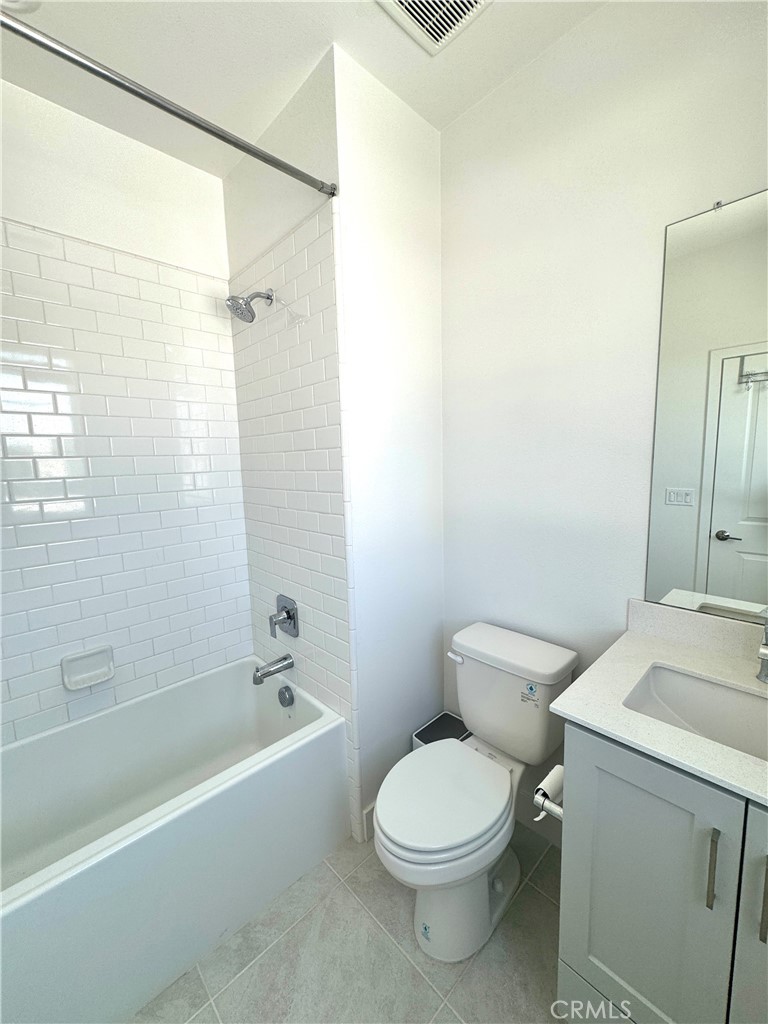 124 Yugen Irvine, CA 92618 - Photo 27 of 31 a white toilet sitting next to a bath tub
