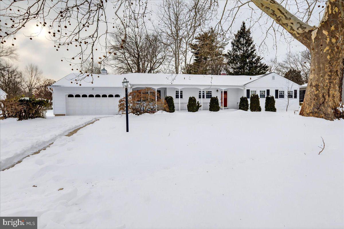 a view of house with yard and sitting area