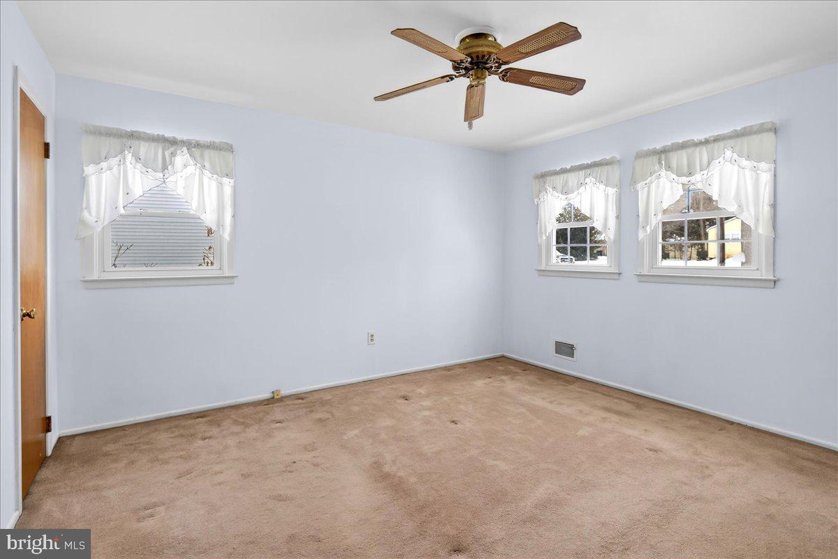 6 Royal Oak Road Lawrence Township, NJ 08648 - Photo 15 of 27 an empty room with windows and fan