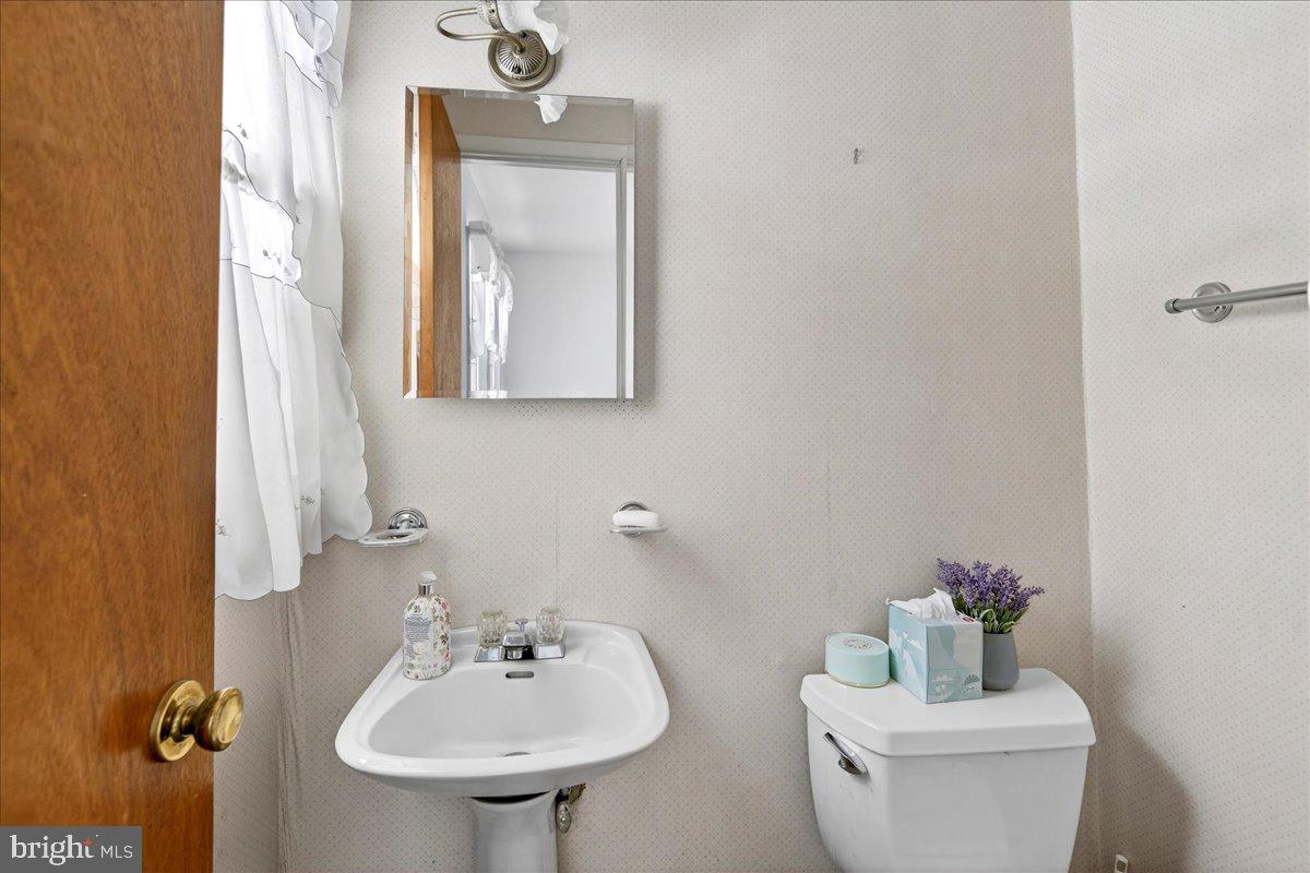 6 Royal Oak Road Lawrence Township, NJ 08648 - Photo 17 of 27 a bathroom with a toilet sink and mirror