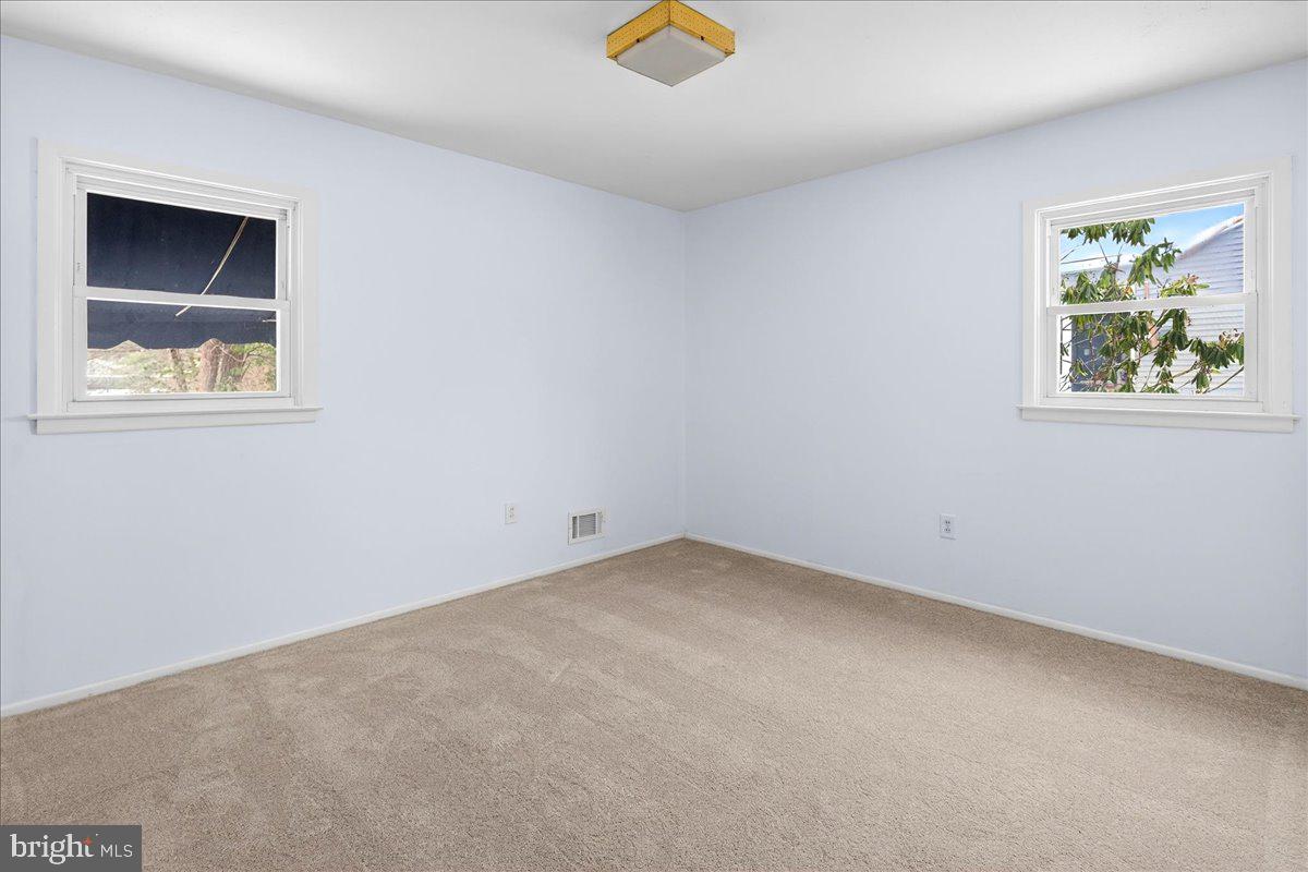 6 Royal Oak Road Lawrence Township, NJ 08648 - Photo 19 of 27 an empty room with a window and a ceiling fan