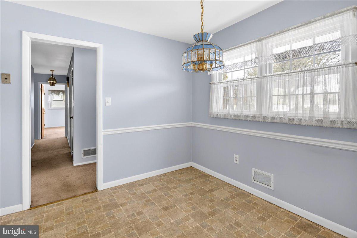 6 Royal Oak Road Lawrence Township, NJ 08648 - Photo 3 of 27 an empty room with a windows and chandelier