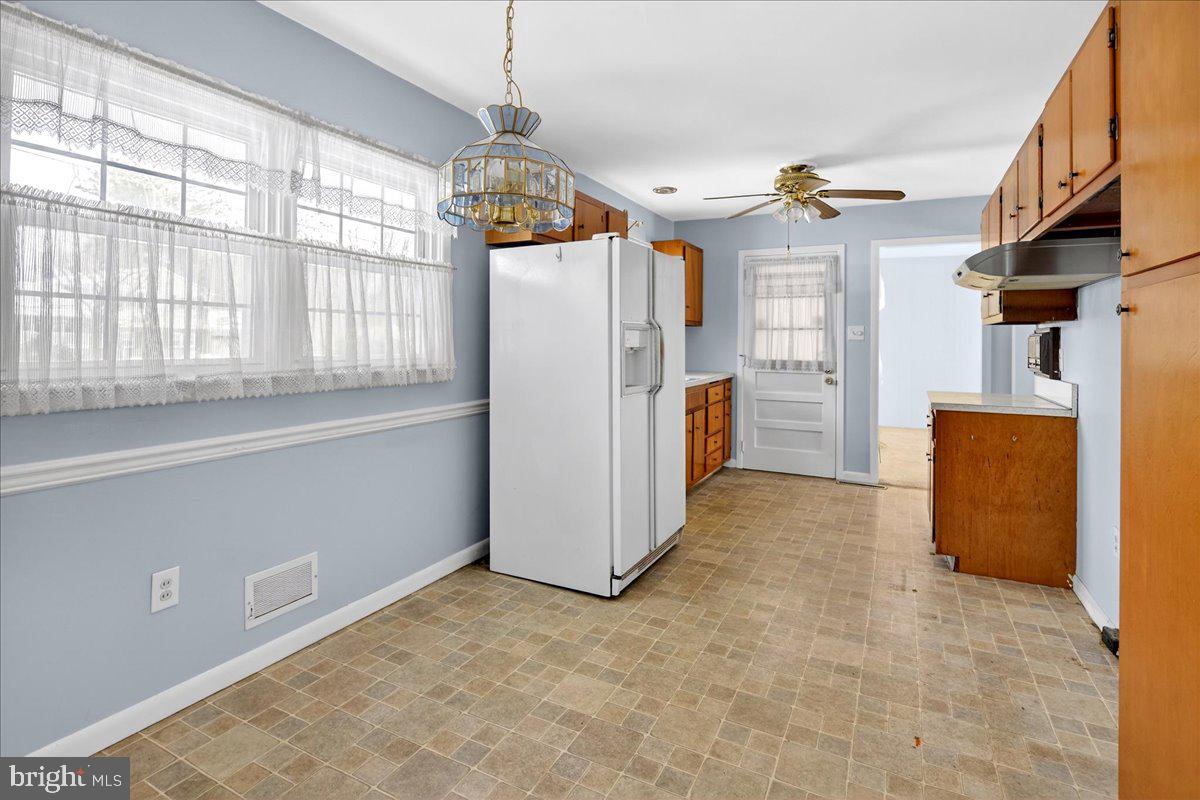 6 Royal Oak Road Lawrence Township, NJ 08648 - Photo 4 of 27 a view of a kitchen with a refrigerator a microwave and a sink