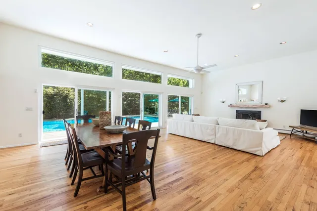 a dining room with furniture wooden floor and chandelier