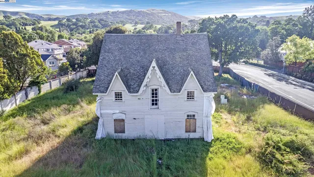 an aerial view of house with a yard