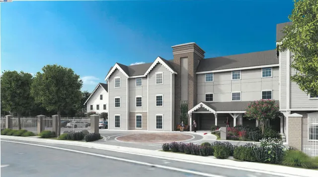 a view of a white building among the street with palm trees