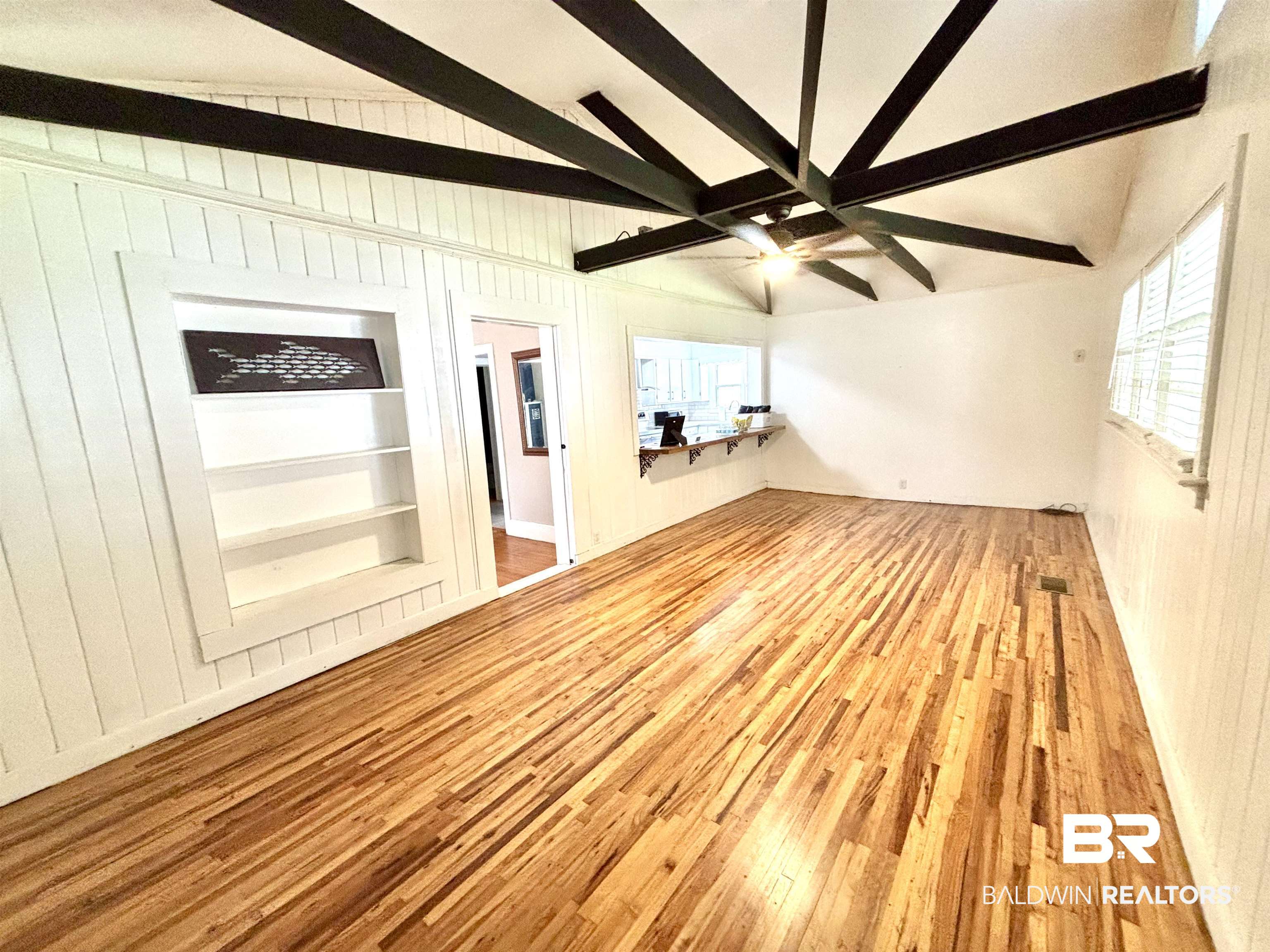 114 Crenshaw Street Mobile, AL 36606 - Photo 23 of 49 Unfurnished room featuring lofted ceiling with beams, built in shelves, wood finished floors, and ceiling fan