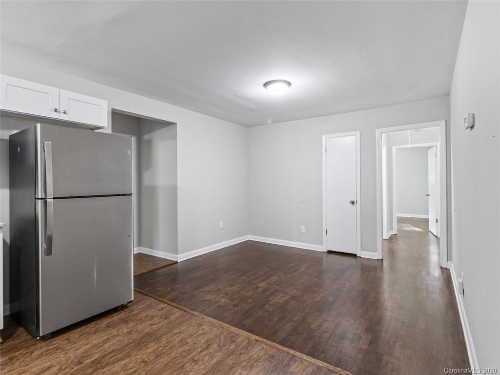 1609 Scott Road Statesville, NC 28625 - Photo 11 of 35 a view of an empty room with wooden floor and a refrigerator