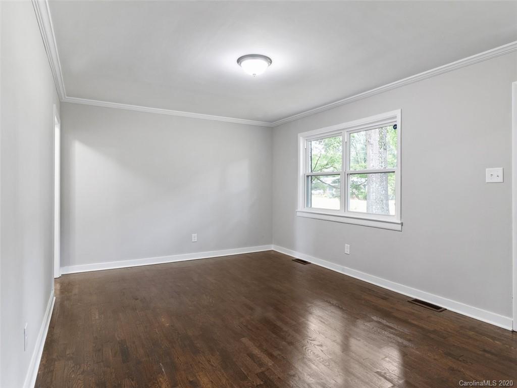 1609 Scott Road Statesville, NC 28625 - Photo 15 of 35 an empty room with wooden floor and windows