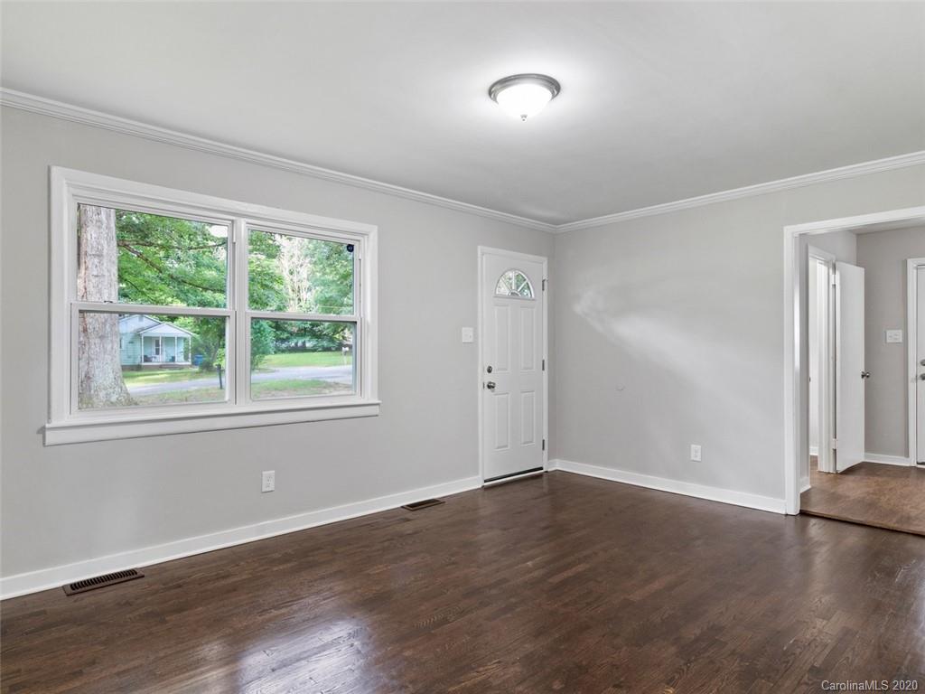 1609 Scott Road Statesville, NC 28625 - Photo 17 of 35 an empty room with wooden floor and windows