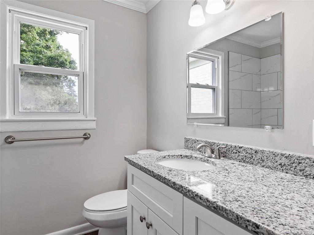 1609 Scott Road Statesville, NC 28625 - Photo 18 of 35 a bathroom with a granite countertop sink a toilet and a window